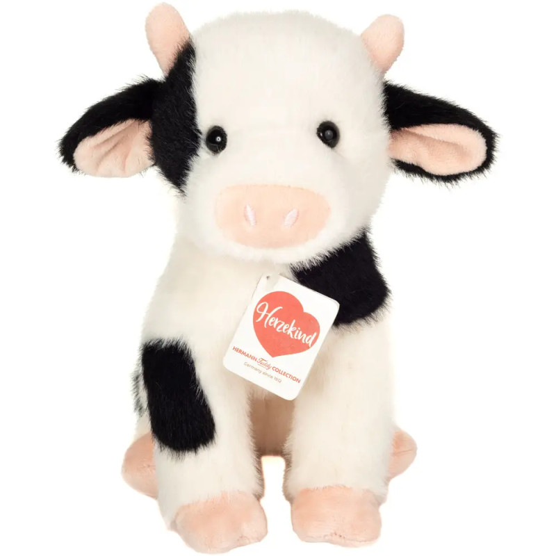 Schwarz-weißes Plüschtier-Kuh mit rosa Nase und einem Halsband, an dem ein Anhänger "Herzekind" hängt.