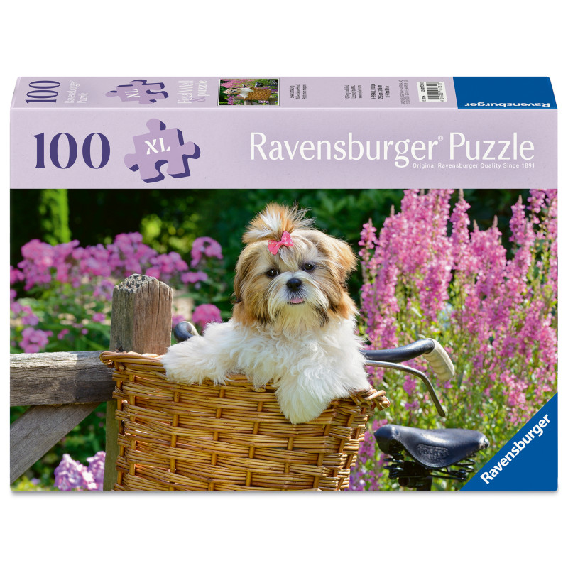 Ein flauschiger Hund mit Schleife sitzt im Fahrradkorb, umgeben von pinken Blumen; Puzzle mit 100 Teilen.