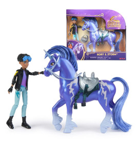 Puppe mit kurzem Haar und Jacke steht neben blauem Einhorn-Spielzeug, im Hintergrund eine Box mit Rory & Storm.