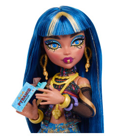 Eine Modepuppe mit langen blauen Haaren hält eine Schokoladentafel und trägt bunte Kleidung und goldene Accessoires.