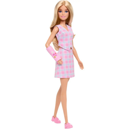 Barbie-Puppe im rosa Kleid, pinken Schuhen und mit einem rosa Gips am Arm, verziert mit Herzen und Smileys.