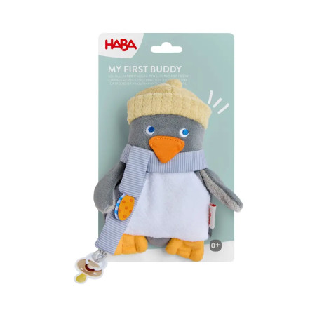 Plüschpinguin mit gelbem Hut und Schal in blauer My First Buddy HABA Verpackung, geeignet ab 0+ Monaten.
