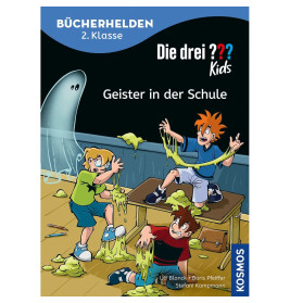 Drei Kinder im Klassenraum erschrecken vor grünem Schleim und einer geisterhaften Gestalt im Hintergrund.