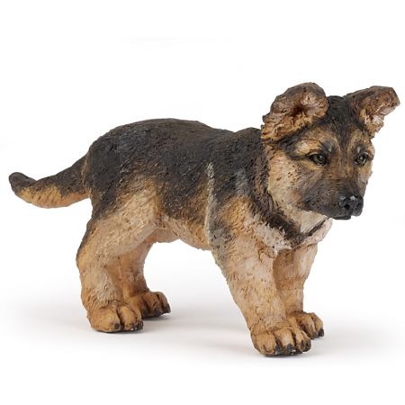 Eine kleine, realistische Figur eines Deutschen Schäferhundwelpen steht auf allen vier Beinen.