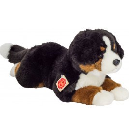 Ein liegender Plüsch-Bernhardiner mit schwarz-weiß-braunem Fell und einem Etikett an der Seite.
