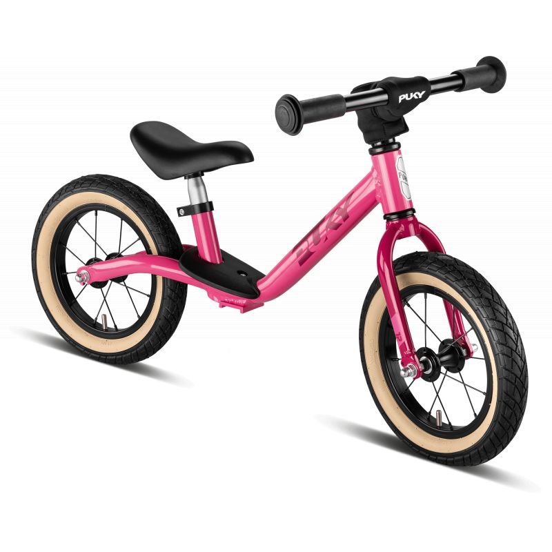 Pinkes Kinderlaufrad mit schwarzem Sitz, Lenker und cremefarbenen Reifen, seitliche Ansicht. Pinkes Kinderlaufrad mit schwarzem Sitz, Lenker und cremefarbenen Reifen, seitliche Ansicht.