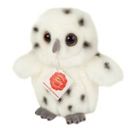 Ein weißes Plüsch-Eulenspielzeug mit schwarzen Flecken, großen braunen Augen und rotem Anhänger auf der Brust.