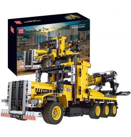 Gelber Baufahrzeug-Baueinsatz mit Verpackung, auf der das fertige Modell des Lastwagens zu sehen ist.