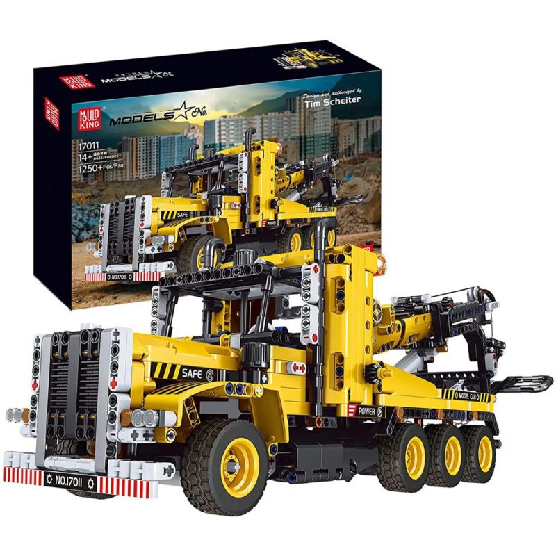 Gelber Baufahrzeug-Baueinsatz mit Verpackung, auf der das fertige Modell des Lastwagens zu sehen ist.