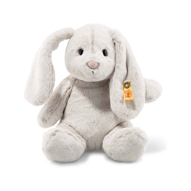 Ein weiches, hellgraues Plüschhäschen mit langen Schlappohren und gelbem Etikett am linken Ohr.