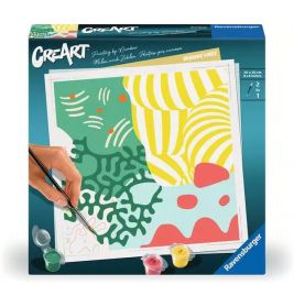 Eine Hand bemalt eine bunte, abstrakte Vorlage auf einem CreArt Malen-nach-Zahlen-Set von Ravensburger.