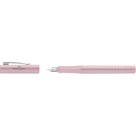 Ein rosa Faber-Castell-Füller mit abgenommener Kappe, der neben dem Stift liegt.