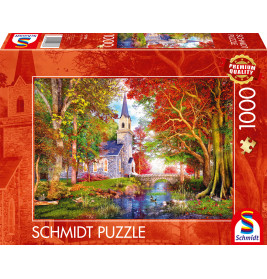 Schmidt Puzzle mit 1000 Teilen: Herbstlandschaft mit Kirche am Fluss auf dem Karton abgebildet.