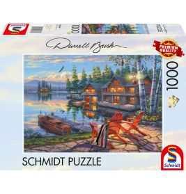 Schmidt Puzzle mit 1000 Teilen: Seehütte, Boote und Adirondack-Stühle bei Sonnenuntergang auf der Verpackung.