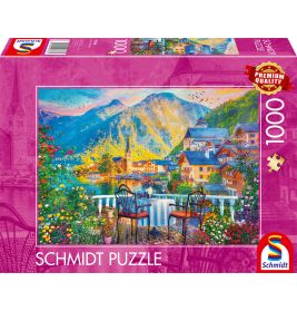 Schmidt Puzzle mit 1000 Teilen: Motiv zeigt malerisches Seedorf mit Bergen und Blumen.