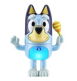 Spielfigur eines blauen Cartoon-Hundes mit leuchtendem Bauch, der eine gelbe-orange Maraca in der Hand hält.