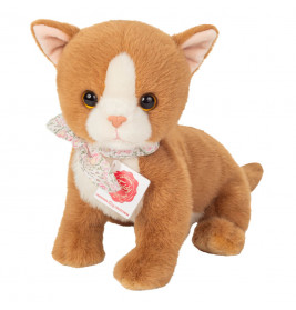 Eine orange-weiße Plüschkatze mit Blumenschal und Halsband sitzt aufrecht.