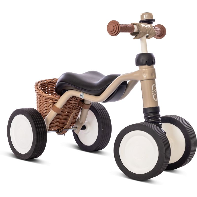 Beige-braunes Kinder-Dreirad mit Korb und schwarzem Sitz, seitlich betrachtet.