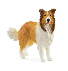 Eine Plastikfigur eines braun-weißen Collies steht mit heraushängender Zunge.