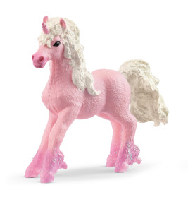 Eine pinke Einhornfigur mit weiß-glitzernder Mähne und Schweif steht auf drei Beinen.