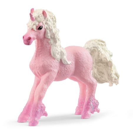Eine pinke Einhornfigur mit weiß-glitzernder Mähne und Schweif steht auf drei Beinen.