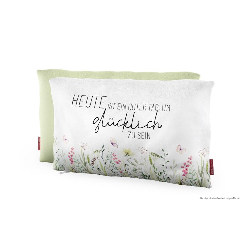 Zwei Dekokissen: eins grün, eins weiß mit Blumenmuster und deutschem Text über Glück.