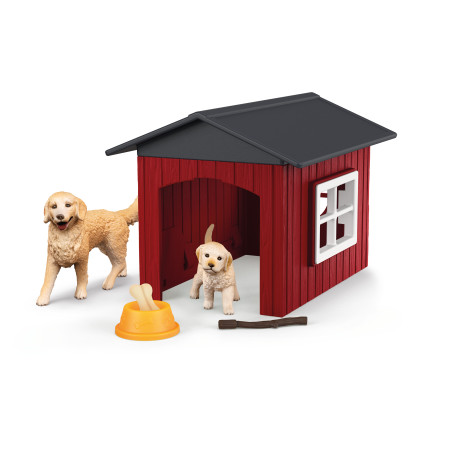 Zwei Spielzeughunde vor einer roten Hundehütte mit schwarzem Dach, gelbem Napf und Stock auf weißem Hintergrund.