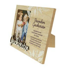 Holzrahmen mit Foto zweier Kinder, Blumenmustern und deutschem Geschwistertext neben dem Bild.