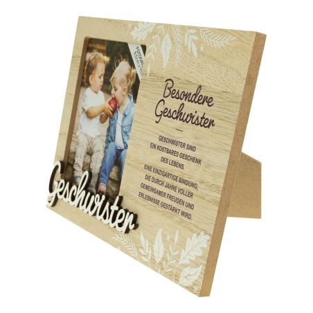 Holzrahmen mit Foto zweier Kinder, Blumenmustern und deutschem Geschwistertext neben dem Bild.