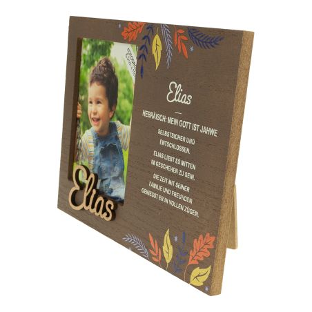 Holzbilderrahmen mit Foto eines lächelnden Kindes, Name Elias, verziert mit bunten Blättern.