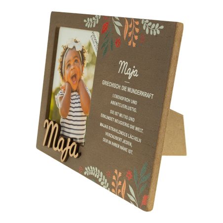 Holz-Bilderrahmen mit Blumenmuster, Foto eines lächelnden Kindes und dem Namen "Maja" als Text.