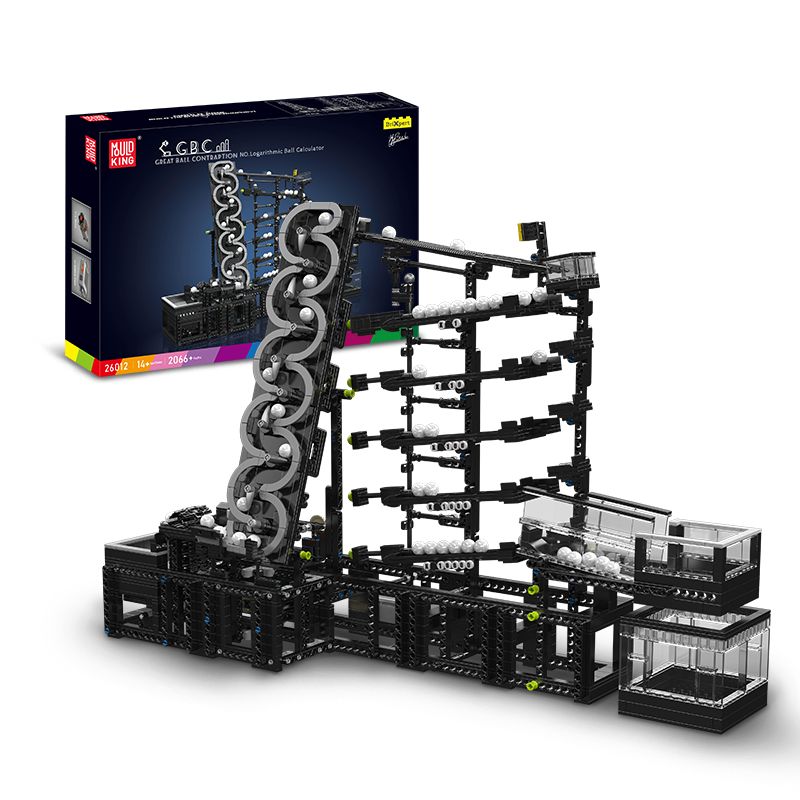 Schwarze und graue Murmelbahn mit weißen Kugeln, im Hintergrund die bunte Verpackung. Schwarze und graue Murmelbahn mit weißen Kugeln, im Hintergrund die bunte Verpackung.