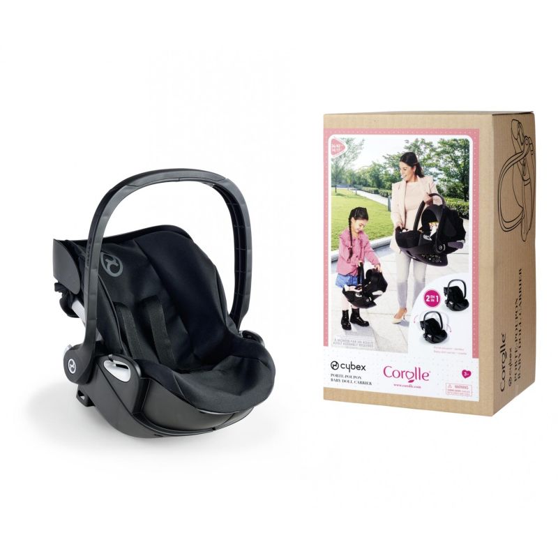 Schwarzer Kindersitz neben Karton mit Bild einer Frau und eines Kindes, die den Sitz tragen.