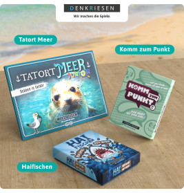 Drei DenkRiesen-Spiele-Tatort Meer, Komm zum Punkt, Haifischen-liegen auf einem Tisch am Strand.