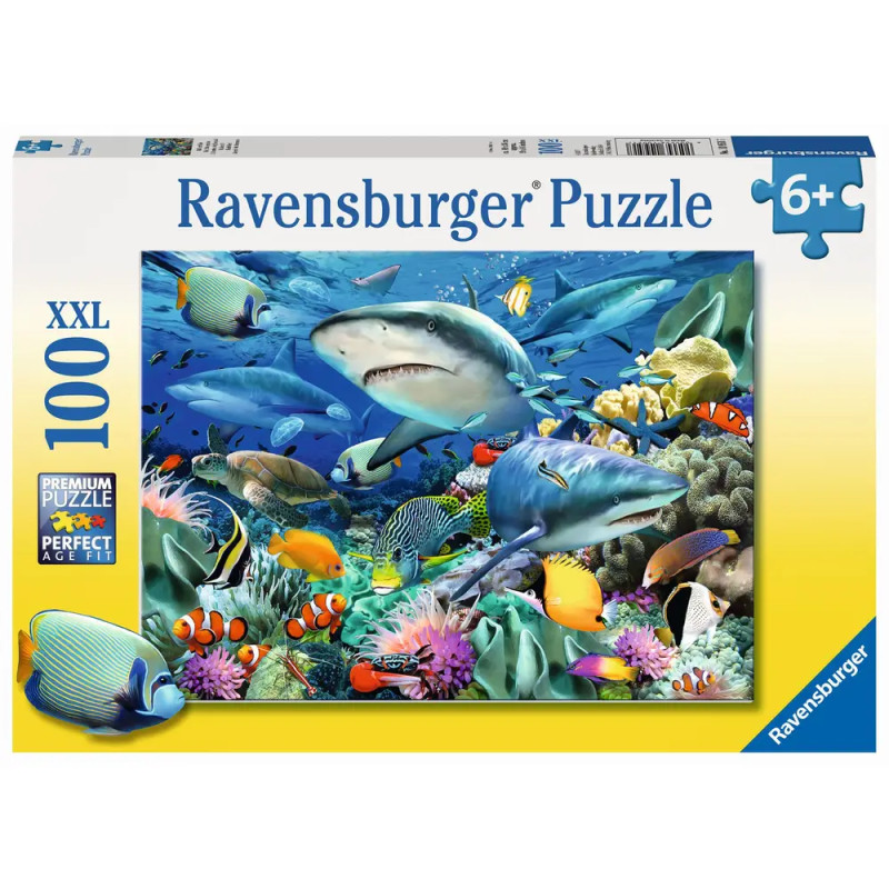 Ravensburger Puzzle mit 100 Teilen: Haie und bunte Fische schwimmen in einer lebendigen Unterwasserlandschaft.