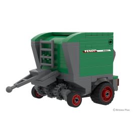 Spielzeugmodell eines grünen und grauen Fendt-Ballers mit roten Rädern, schräg betrachtet.