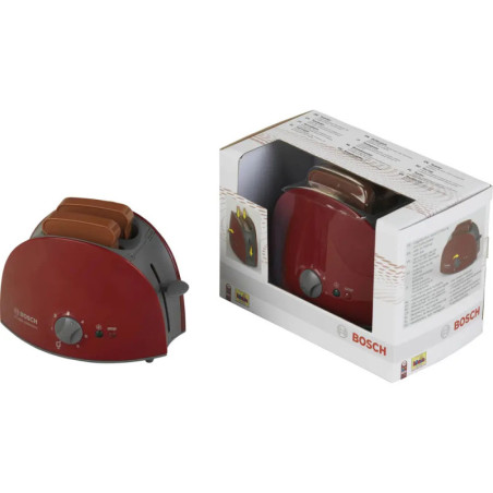 Roter Bosch-Toaster mit zwei Brotscheiben steht neben seiner Verpackung. Roter Bosch-Toaster mit zwei Brotscheiben steht neben seiner Verpackung.
