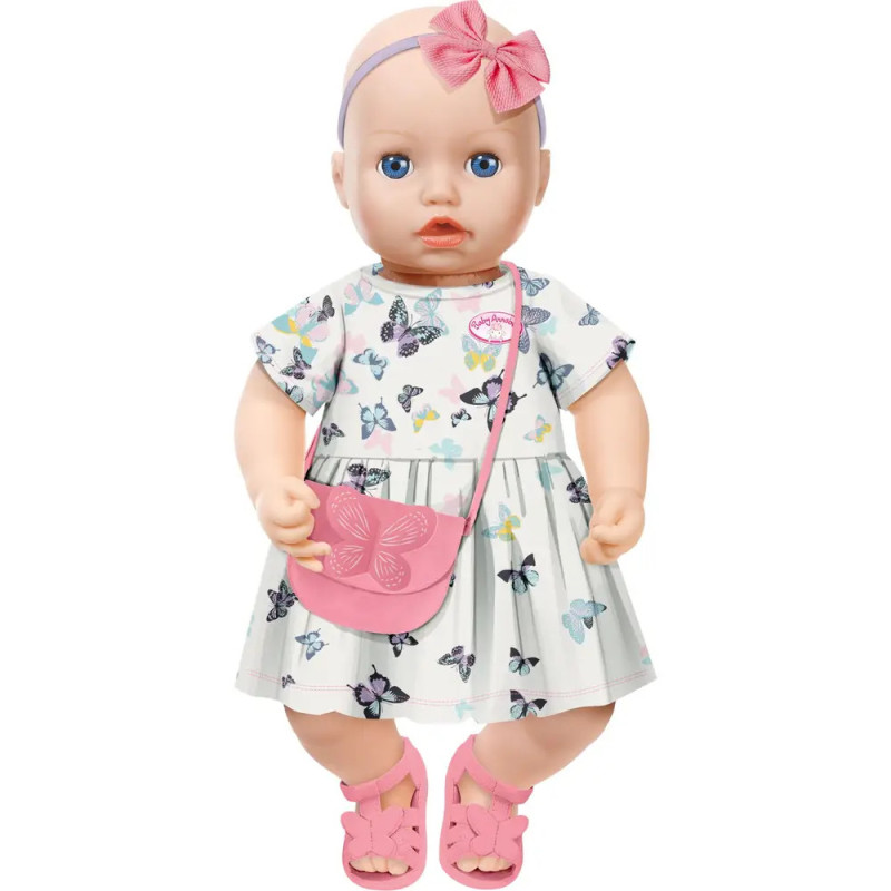 Babypuppe mit blauen Augen, Schmetterlingskleid, rosa Sandalen, Haarband und rosa Tasche. Babypuppe mit blauen Augen, Schmetterlingskleid, rosa Sandalen, Haarband und rosa Tasche.