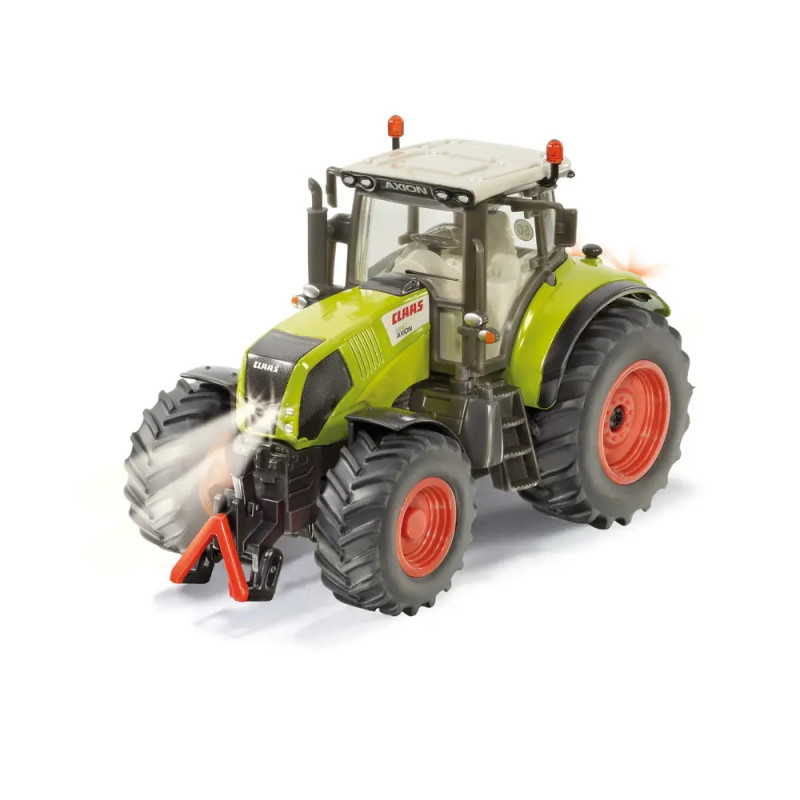 Grüner Spielzeugtraktor mit roten Rädern und klarem Führerhaus, schräg von vorne links auf weißem Hintergrund. Grüner Spielzeugtraktor mit roten Rädern und klarem Führerhaus, schräg von vorne links auf weißem Hintergrund.