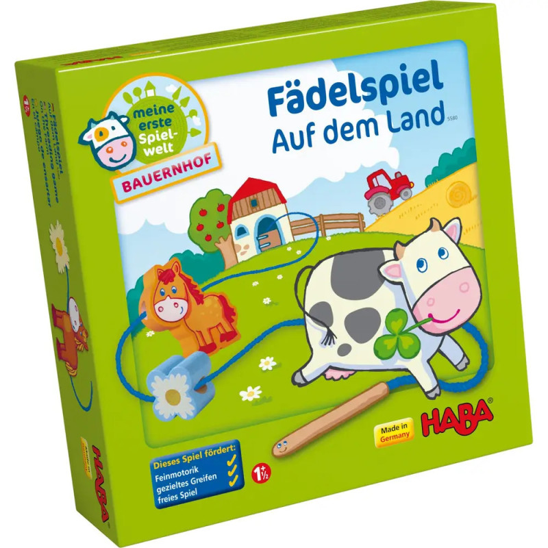 HABA Fädelspiel Auf dem Land: Schachtel mit Kuh, Pferd, Scheune und grünen Feldern.