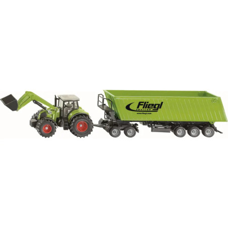 Grüner Spielzeugtraktor mit Frontlader, angehängt an einen grünen Fliegl-Anhänger mit sechs Rädern auf weißem Hintergrund.