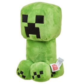 Grünes Plüschtier, das einem Minecraft Creeper ähnelt, mit quadratischen schwarzen Augen und Mund, sitzt aufrecht.