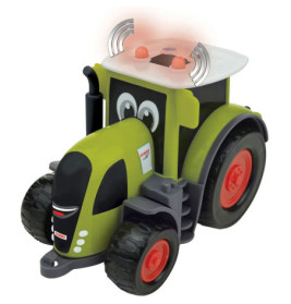 Grüner Spielzeugtraktor mit Cartoon-Augen, roten Rädern und Blinklichtern auf weißem Hintergrund.