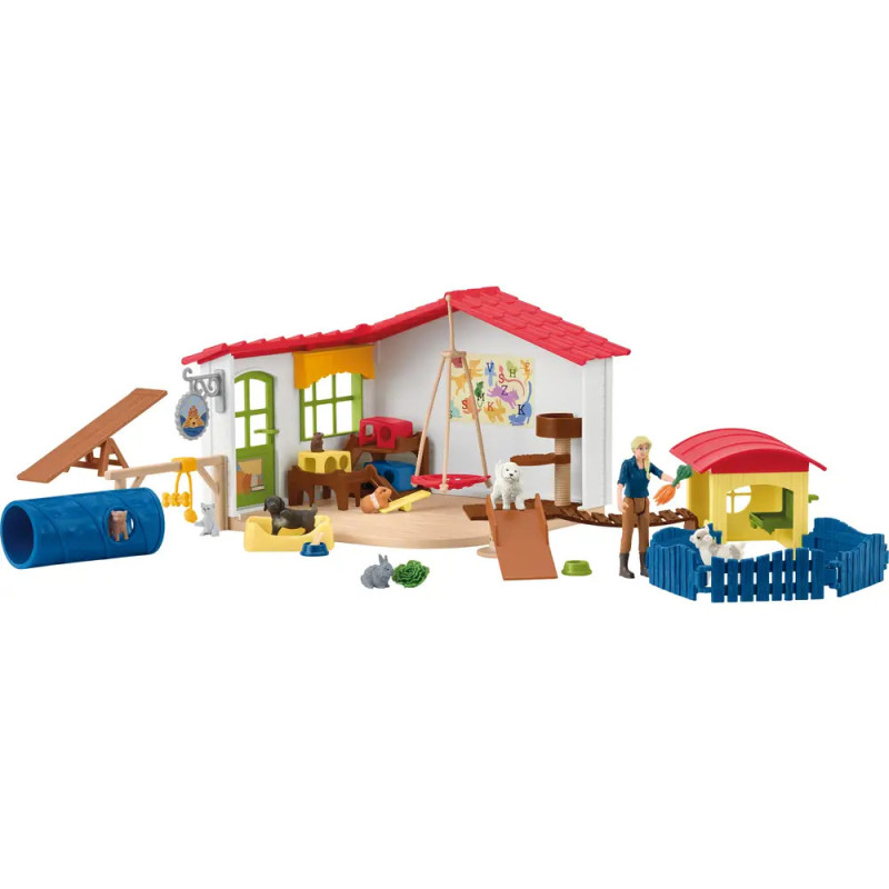 Kinderspielset mit Spielzeug-Scheune, Tieren, Figuren, Zäunen, Tunnel und Zubehör auf weißem Hintergrund.