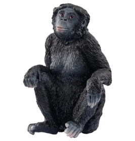 Plastikmodell eines sitzenden schwarzen Affen mit strukturiertem Fell und leicht geneigtem Kopf.