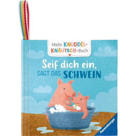 Zwei gezeichnete Schweinchen in einer Schaumwanne auf einem Kinderbuch mit deutschem Text und Regenbogenschleife.