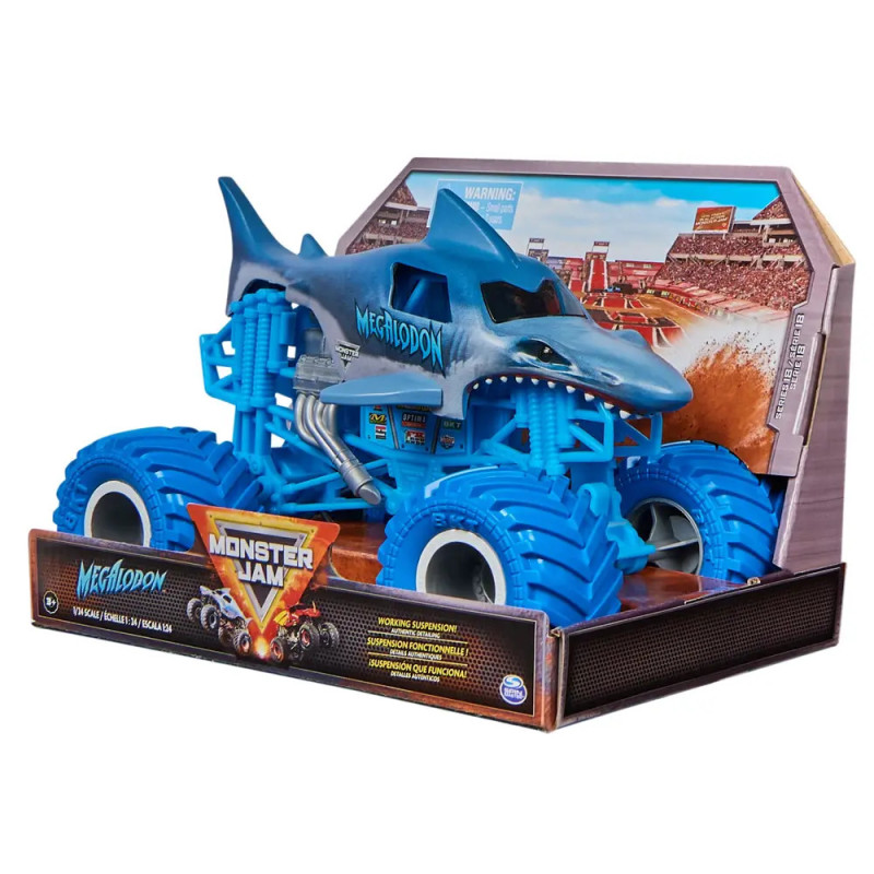 Blauer Megalodon-Monstertruck als Spielzeug im Hai-Design in Verpackung vor Stadion-Hintergrund.