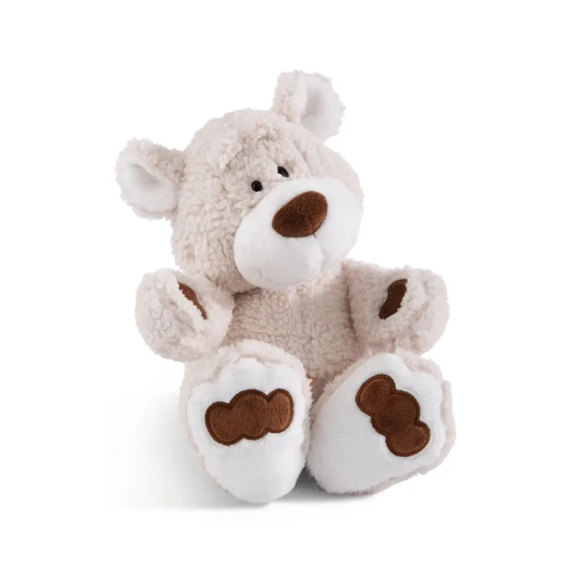 Beiger Plüsch-Teddybär mit braunen Flecken an Pfoten und Nase, sitzt aufrecht. Beiger Plüsch-Teddybär mit braunen Flecken an Pfoten und Nase, sitzt aufrecht.