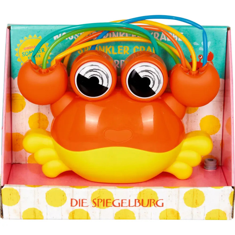 Orange-gelbes Krabben-Sprinklerspielzeug mit großen Augen in bunter Verpackung, beschriftet mit Die Spiegelburg. Orange-gelbes Krabben-Sprinklerspielzeug mit großen Augen in bunter Verpackung, beschriftet mit Die Spiegelburg.