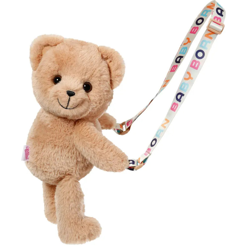 Ein brauner Plüsch-Teddybär hält ein buntes Band mit der Aufschrift BABY BORN in farbigen Buchstaben. Ein brauner Plüsch-Teddybär hält ein buntes Band mit der Aufschrift BABY BORN in farbigen Buchstaben.